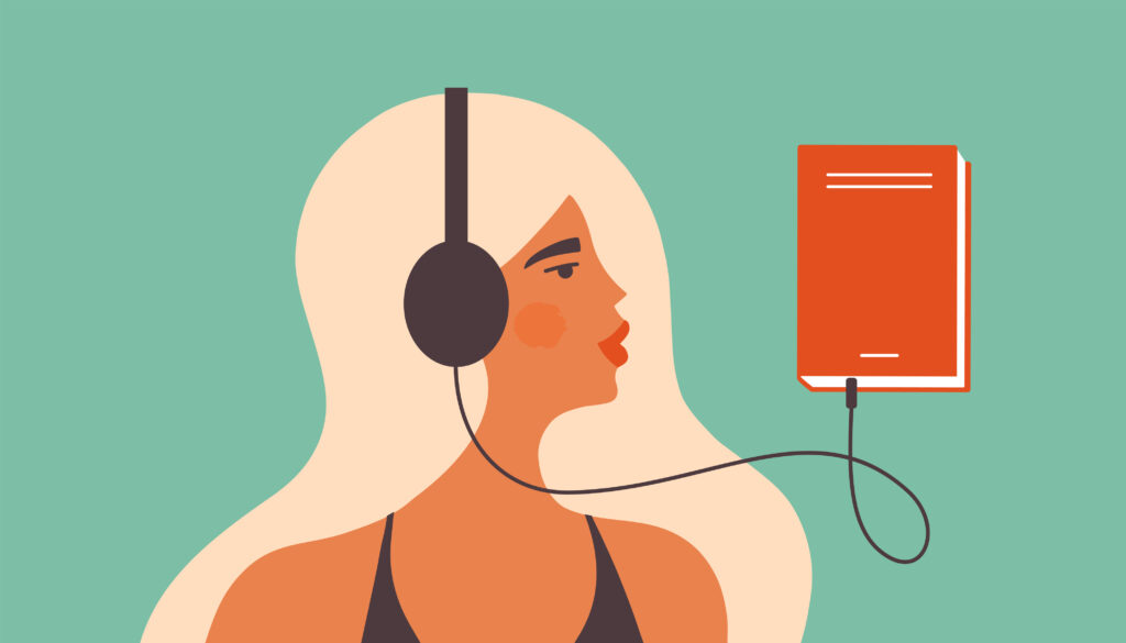 Mujer rubia con audífonos conectados a un libro.