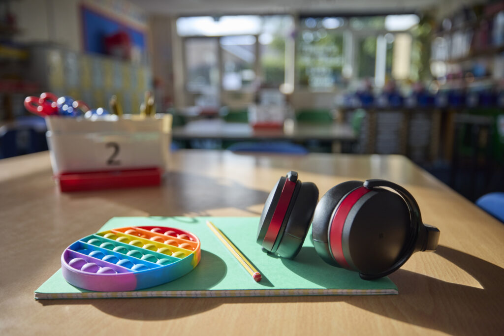 Audífonos y un juguete para gestionar ansiedad en un salón de clases