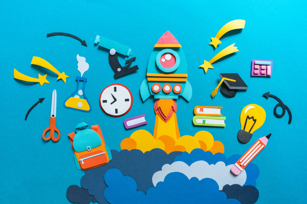 Rocket takes off paper craft. Back to school. Copy space. Blue background. Education concept